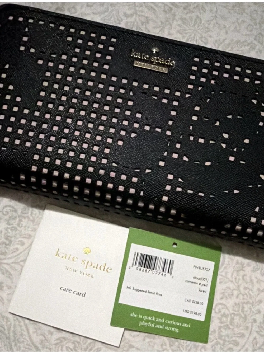 kate spade black perforated wallet with pink underlay